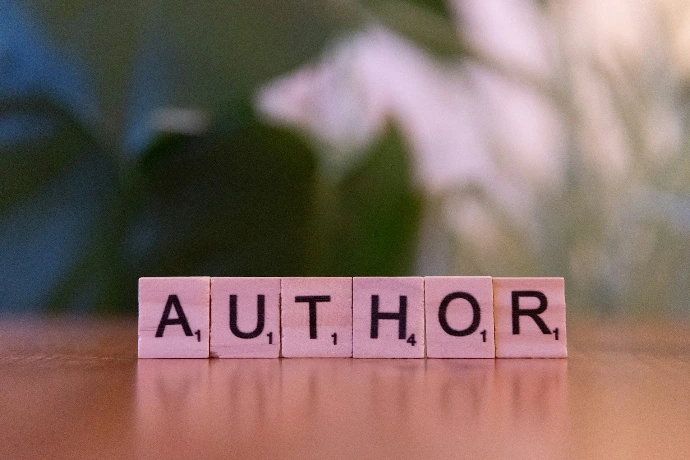 A scrabble type block spelling the word author